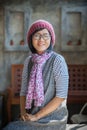 portrait of 40s years asian woman wearing wool hood and silk scarf toothy smiling with happiness emotion