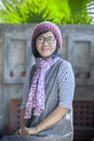 portrait of 40s years asian woman wearing wool hood and silk scarf toothy smiling with happiness emotion