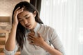 Portrait of 20s young Asian woman having difficulty breathing in bedroom at night. Shortness of breath, asthma Royalty Free Stock Photo