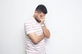 Portrait of sad alone handsome bearded young man in striped t-shirt standing, holding his head down and crying Royalty Free Stock Photo