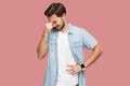 Portrait of sad alone hopeless bearded young man in blue casual style shirt standing, holding his head down and crying Royalty Free Stock Photo