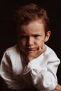 portrait of a sad angry child preschooler boy