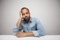 Close-up portrait of a sad black man in his 20s isolated on a white background. Royalty Free Stock Photo