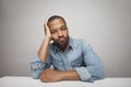 Close-up portrait of a sad black man isolated on a white background. Horizontal. Royalty Free Stock Photo