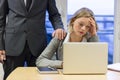 Portrait of sad businesswoman with her boss at background. Hand Royalty Free Stock Photo