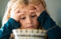 Portrait of sad child having breakfast at home. Portrait of sweet little kid boy with blonde hair eating soup from plate Royalty Free Stock Photo