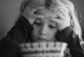 Portrait of sad child having breakfast at home. Portrait of sweet little kid boy with blonde hair eating soup from plate Royalty Free Stock Photo