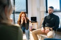 Portrait of sad crying young woman sharing problem sitting in circle during group therapy session. Royalty Free Stock Photo