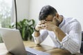 Portrait of a sad and depress mexican businessman working at modern home office with computer laptop Royalty Free Stock Photo