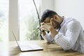 Portrait of a sad and depress mexican businessman working at modern home office with computer laptop Royalty Free Stock Photo