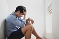 Portrait of sad and depressed man sitting at walkway of condominium or office with ,sad mood,feel tired and unhappy