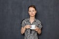 Portrait of sad dreamy young woman holding white cup with tea in hands Royalty Free Stock Photo