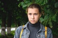 Portrait of a sad girl in a Park on a background of greenery close-up. Royalty Free Stock Photo