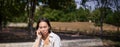 Portrait of sad girl talking on mobile phone and sulking. Young woman having an uneasy conversation on telephone Royalty Free Stock Photo