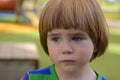 Portrait of a sad little boy in playground Royalty Free Stock Photo