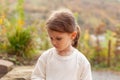 Portrait of a sad little girl in a white T-shirt