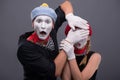 Portrait of sad mime couple crying on