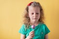 Portrait of a sad, offended little girl with cake pops in her hand. Royalty Free Stock Photo