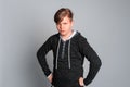 Portrait of sad offended teen boy having offended facial expression, isolated on gray background, wearing in casual clothes