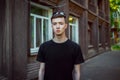 Portrait of sad and pensive handsome young man standing near old building Royalty Free Stock Photo