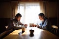 Portrait of sad poor mature couple praying at the table indoors at home, poverty concept. Royalty Free Stock Photo