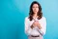 Portrait of sad scared brunette girl hold telephone look empty space wear shirt isolated on teal color background Royalty Free Stock Photo