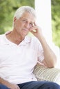 Portrait Of Sad Senior Man Relaxing In Chair Royalty Free Stock Photo