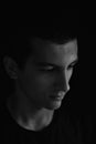 Portrait of sad and serious teenager looking to the side. Concept teenage problems. Black and white. Lights and shadows Royalty Free Stock Photo