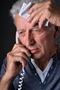 Portrait of sad sick senior man calling doctor Royalty Free Stock Photo