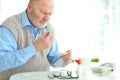 Portrait of sad sick senior man taking pills Royalty Free Stock Photo