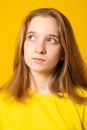 Portrait of sad teenager girl with beautiful gray eyes. Pensive young woman with gray-blue eyes