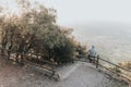 Portrait of a Sad or unhappy man sitting on a railing at Sunset Royalty Free Stock Photo