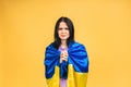 Portrait of sad unhappy woman holding in hands Ukrainian flag having fun Royalty Free Stock Photo