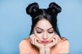 Portrait of sad and upset brunette woman with hair of mouse on blue background Royalty Free Stock Photo