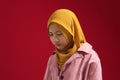 Portrait of sad young Asian teenage muslim girl wearing hijab looking down and depressed Royalty Free Stock Photo