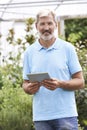 Portrait Of Sales Assistant In Garden Center With Digital Tablet Royalty Free Stock Photo