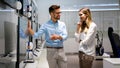 Portrait of salesman helping to woman to buy a new digital device in tech shop Royalty Free Stock Photo