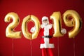 Portrait of Santa Claus with balloons in shape of figures 2019 on color background Royalty Free Stock Photo