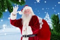 Portrait of santa claus gesturing against digitally generated background Royalty Free Stock Photo