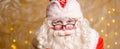 Portrait of santa claus in glasses looking at camera against background Royalty Free Stock Photo