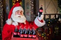 Portrait of Santa Claus holding a package of Coca Cola bottles. Christmas greeting card