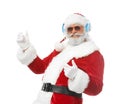 Portrait of Santa Claus listening to music and dancing on white background Royalty Free Stock Photo