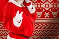 Composite image of portrait of santa claus pointing while carrying christmas bag Royalty Free Stock Photo