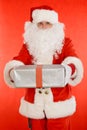 Santa Claus holding nicely wrapped present Royalty Free Stock Photo