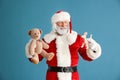 Portrait of Santa Claus with toys on color background Royalty Free Stock Photo