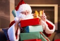 Portrait of Santa with pile of Christmas presents