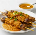 portrait of sate padang with yellow sauce on white background. Royalty Free Stock Photo