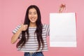 Portrait of satisfied buyer, happy asian woman smiling, showing thumbs up and holding shopping bag with white copy space