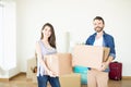 Satisfied Couple Carrying Corrugated Boxes While Moving To New H