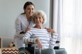 Portrait of satisfied elderly patient in wheelchair and caring caregiver Royalty Free Stock Photo